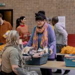 Volunteer at a shelter helping a woman in need.