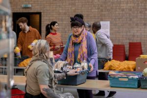 Volunteer at a shelter helping a woman in need.