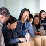 Volunteers preparing food bags as part of emergency support for food access partners.